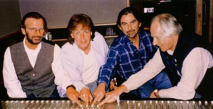 Harrison, McCartney, Starkey & Martin use a ouija board to ask John for more songs...